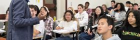 Professor Vetri Nathan, standing, with students seated and listening to his lecture.